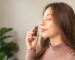 A woman inhaling essential oils to help with allergies
