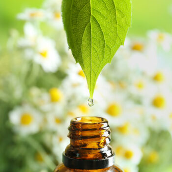 A summer essential oil being dripped into a bottle