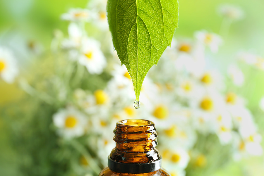 A summer essential oil being dripped into a bottle